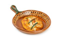 Chile Relleno: A classic chile relleno dipped in fluffy egg batter, simmered in a rich tomato‑based sauce, and topped with melted cheese and fresh garnishes