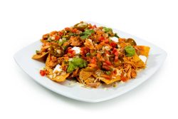 Super Nacho Pollo: Includes shredded pollo, crispy tortilla chips, nacho cheese, sour cream, pico de gallo, guacamole, onions, cilantro, and jalapeños.
