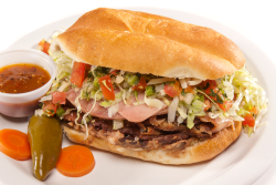 Torta Breakfast: A warm, hearty breakfast sandwich served on a toasted bolillo roll, filled with fluffy eggs, melted cheese, refried beans, and your choice of breakfast meat. Simple, satisfying, and perfect any time of day.