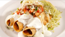 Chicken Taquito Combo Plate: Crispy rolled chicken taquitos served golden‑fried and topped with cool crema, fresh pico de gallo, shredded cheese, and creamy guacamole. Plated over a bed of lettuce and served with rice and beans on the side for a complete, satisfying meal.
